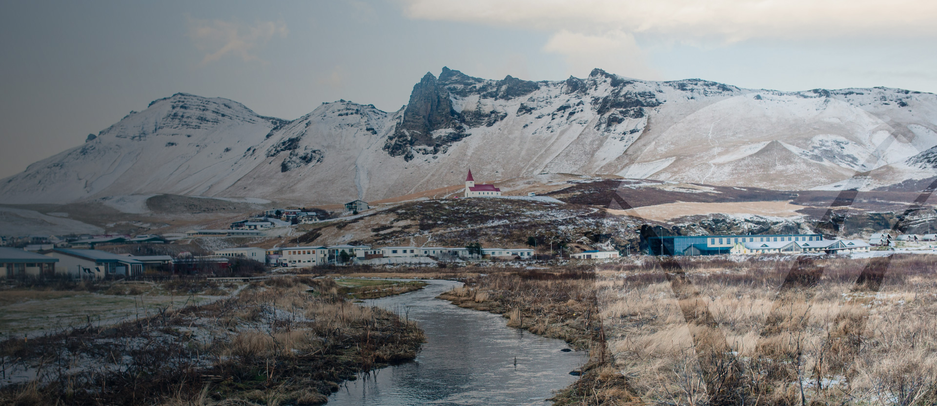 Mountainous landscape image with a winding river in the foreground. Better Homes and Gardens Real Estate
