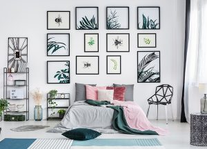 Bright sunny bedroom featuring a variety of modern-style wall art