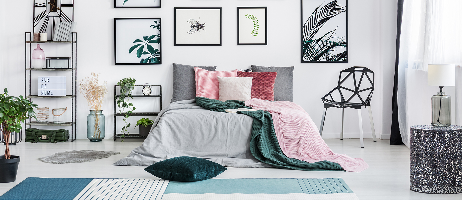 Bright sunny bedroom featuring a variety of modern-style wall art