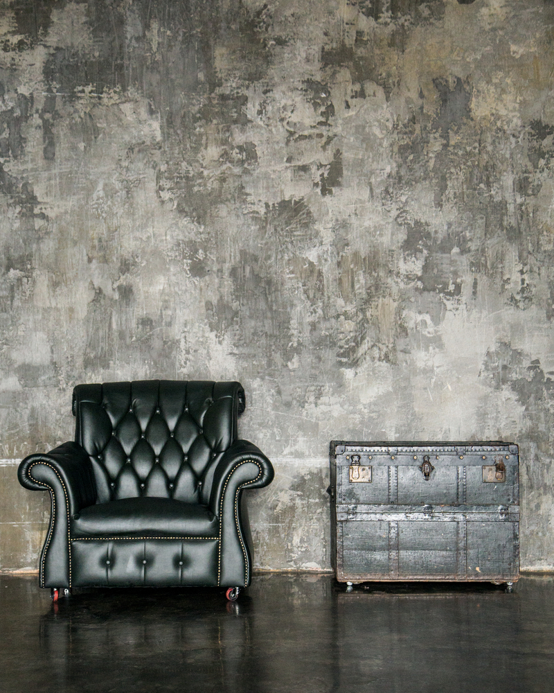 vintage leather chair next to vintage storage chest used as table