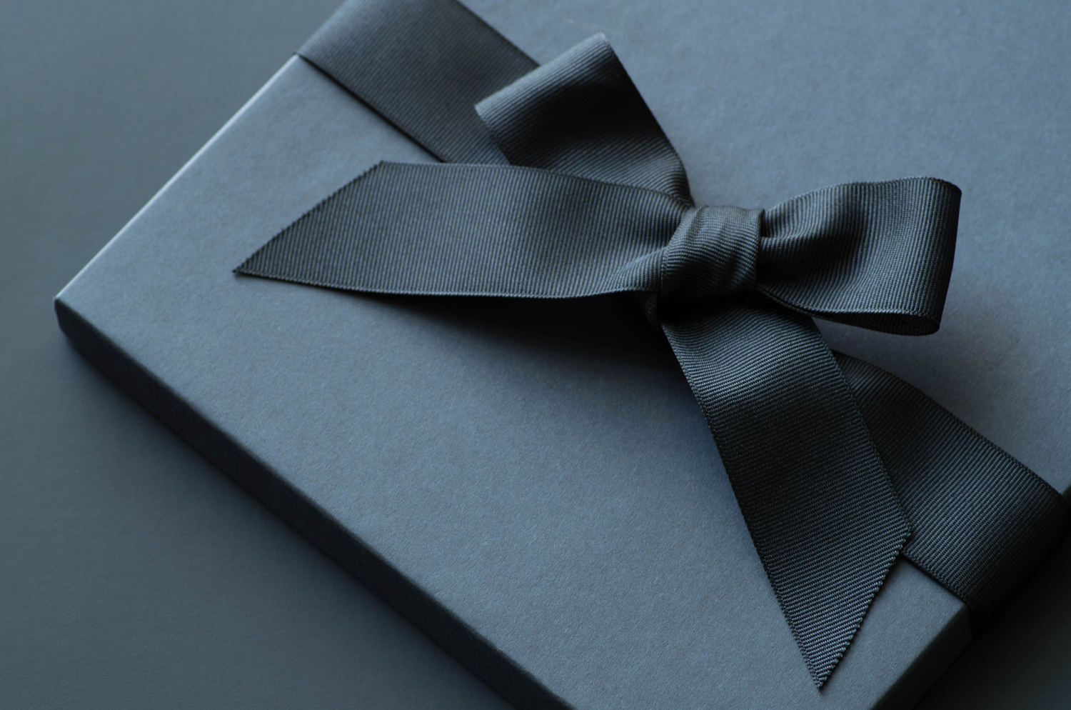 black gift box with black ribbon