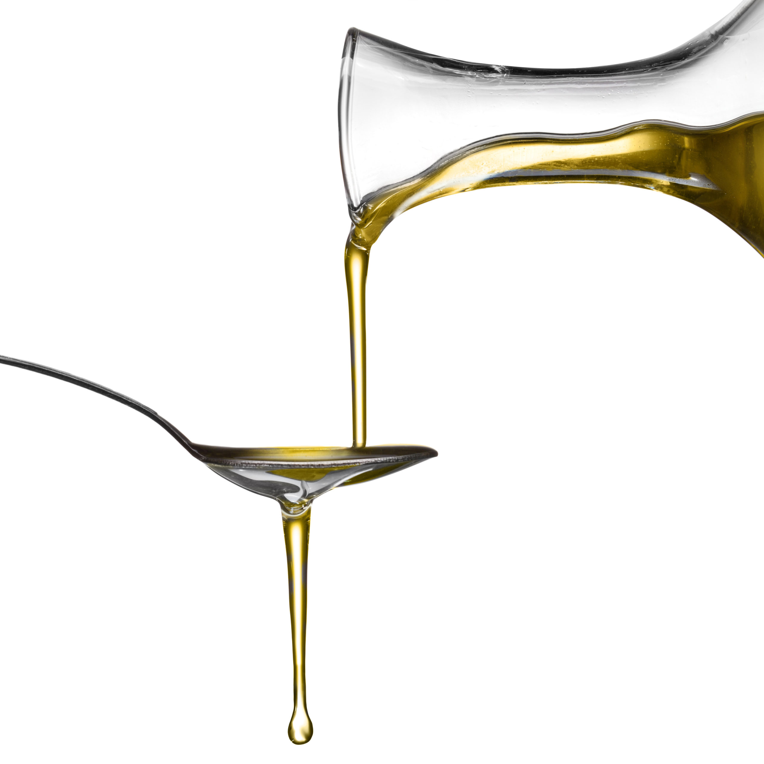 olive oil being poured on a spoon