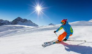 downhill skier in sunshine