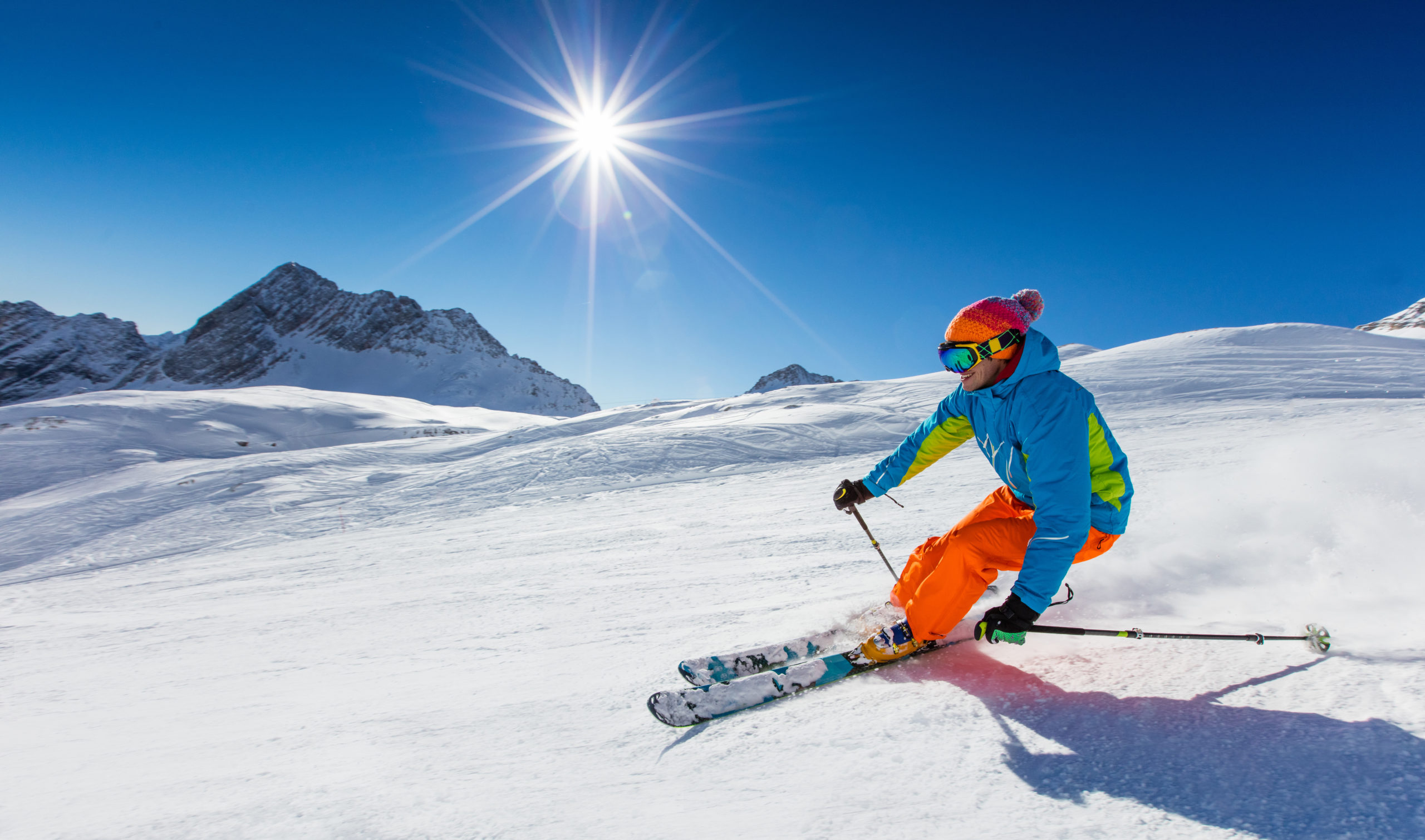 downhill skier in sunshine