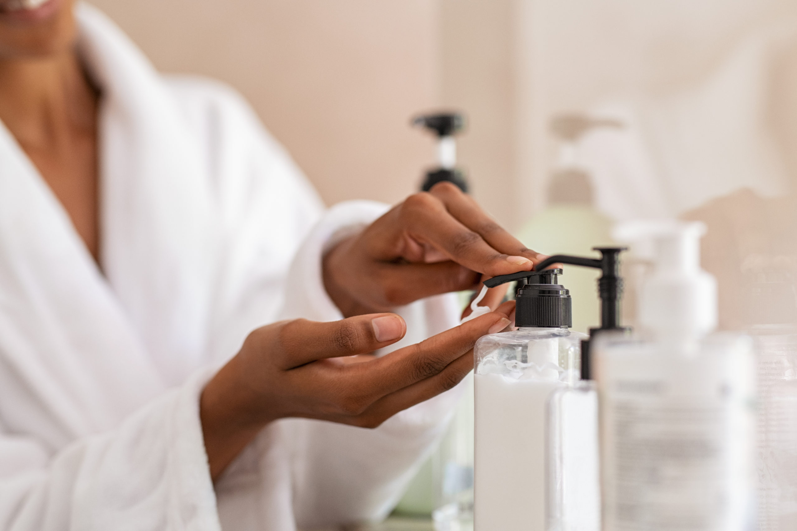 woman in bathroom with toiletries