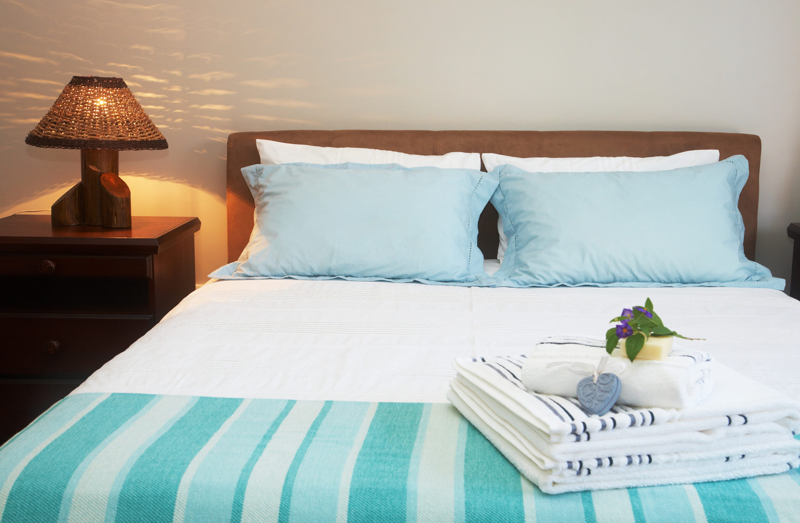 guestroom with little touches like towels, snack